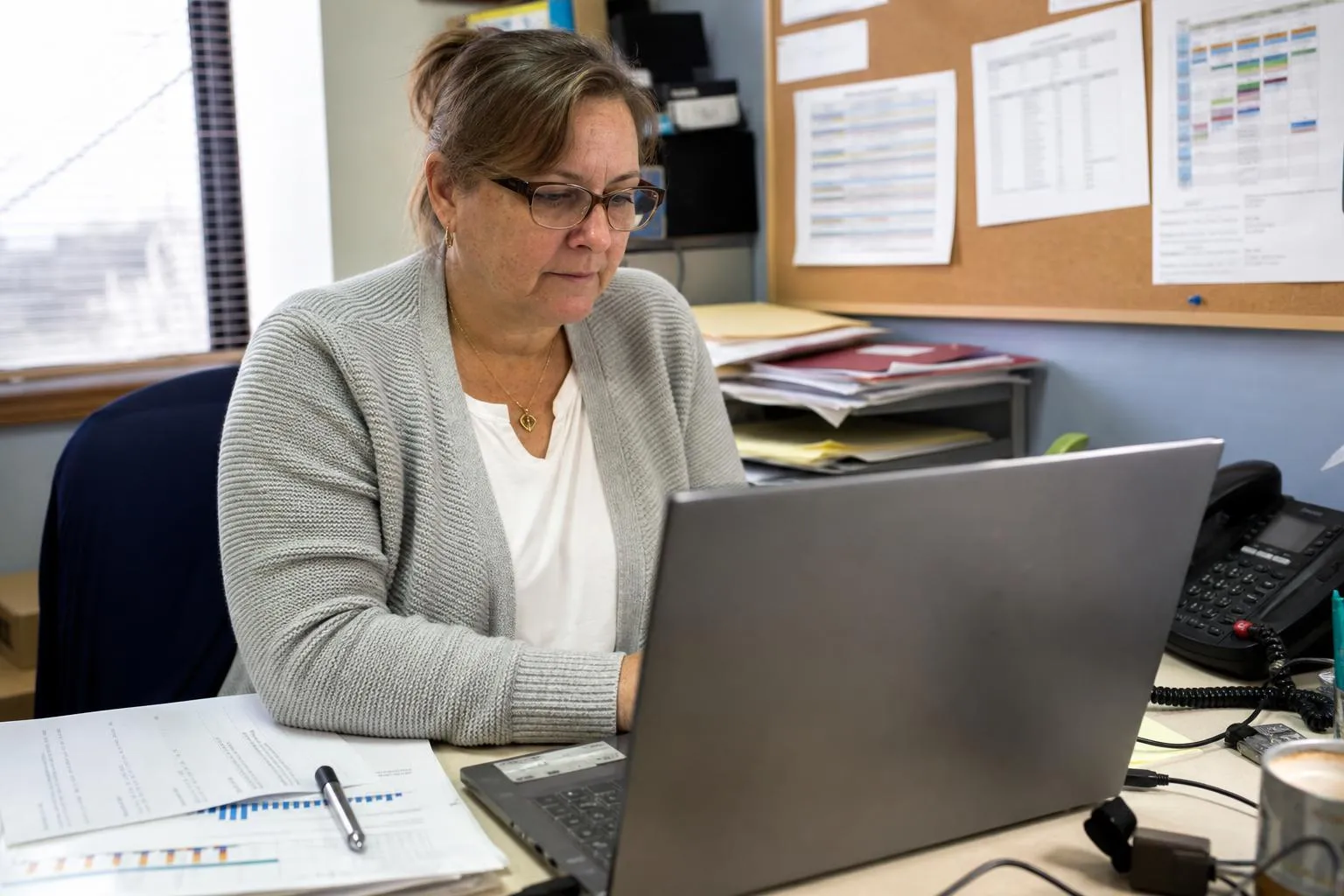 A practice administrator reviewing scheduling and call activity reports on a laptop