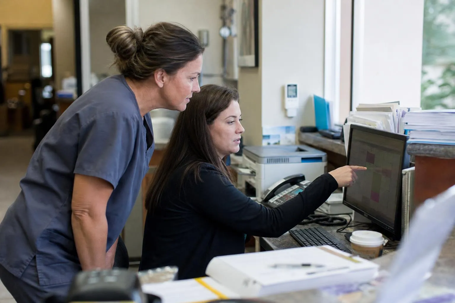 A dental front desk coordinator viewing open appointment slots on a practice management screen
