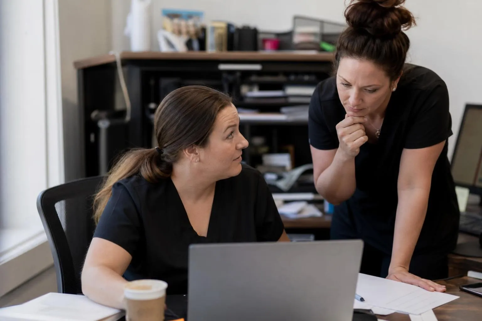A practice owner reviewing response time and booking reports on a laptop